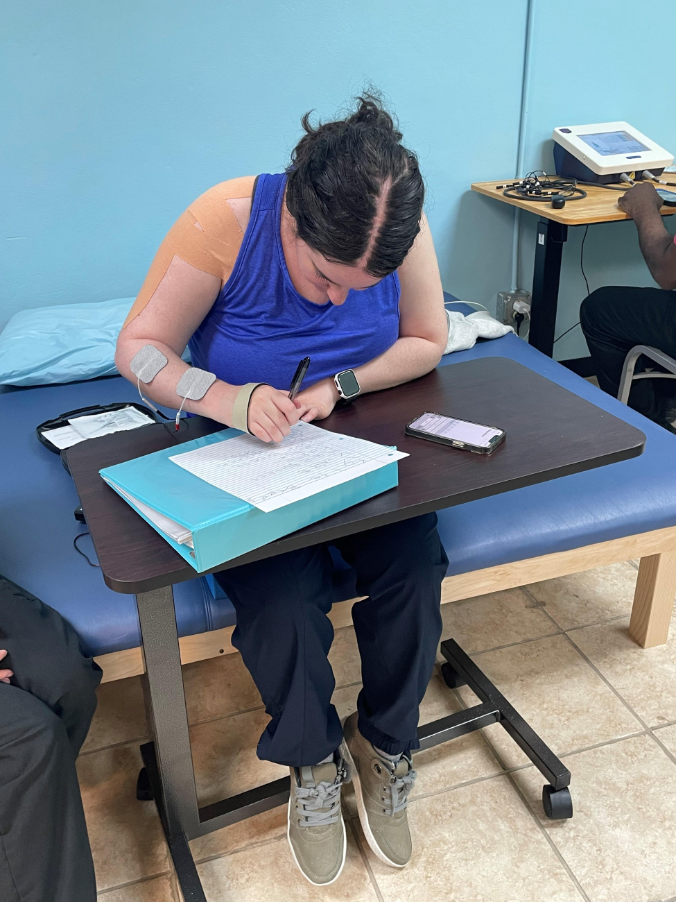 Katie Breece practices writing as part of her rehabilitation therapy after experiencing a stroke at 27 years old. (Photo courtesy of Katie Breece)